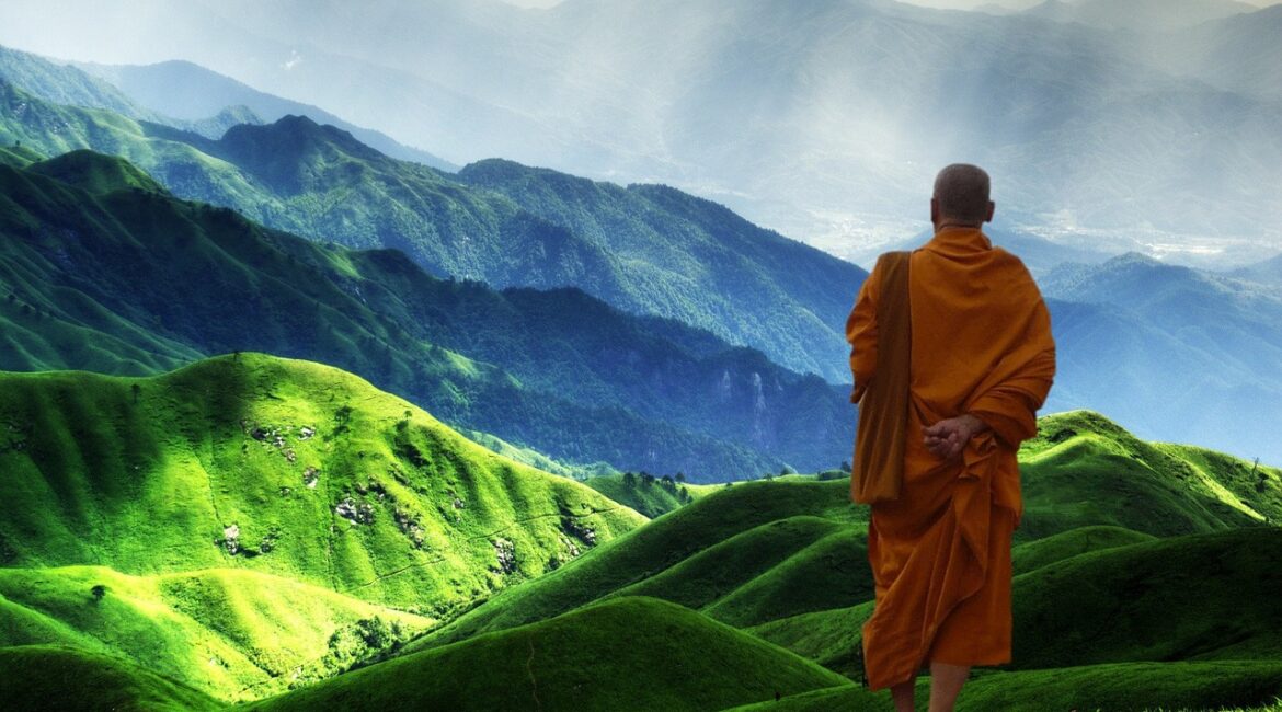 A Tibetan monk looking at the mountains