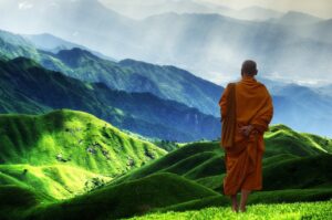 A Tibetan monk looking at the mountains