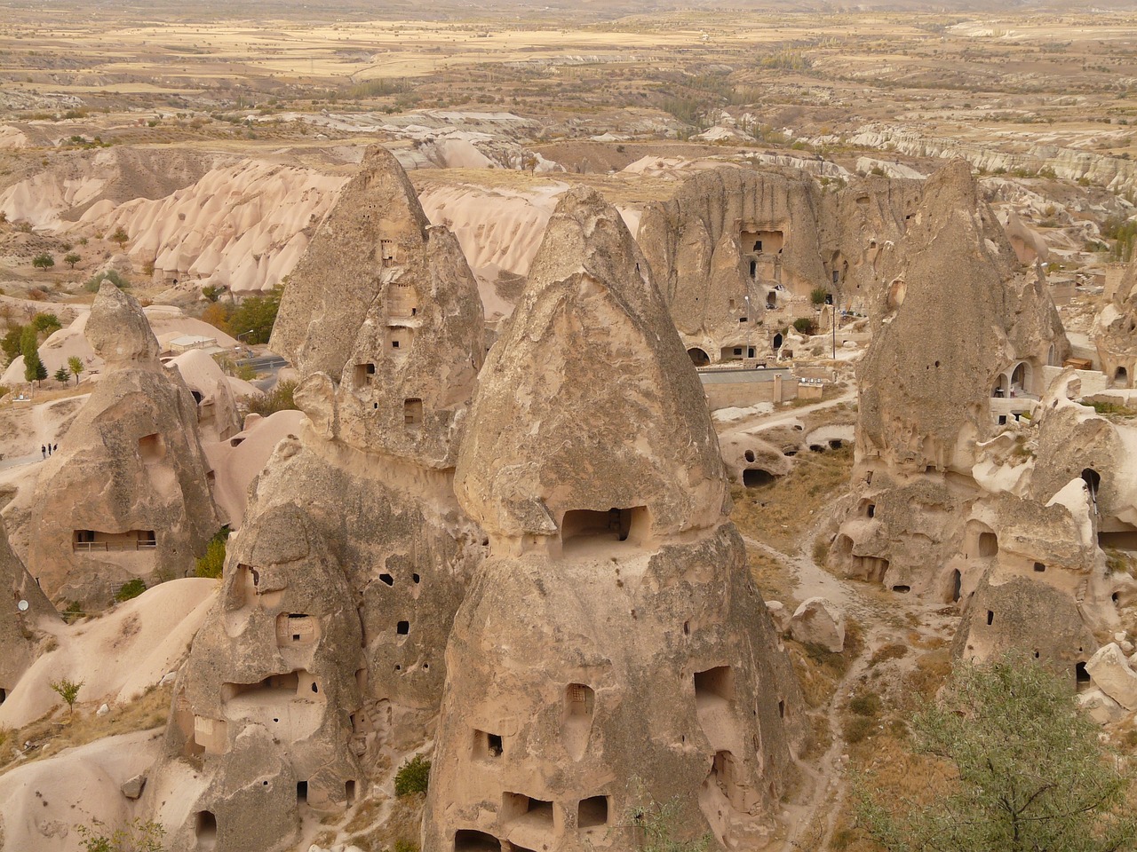 Aerial view of cave dwellings and rock-cut architecture in ancient Cappadocian settlement showing multiple levels of habitation